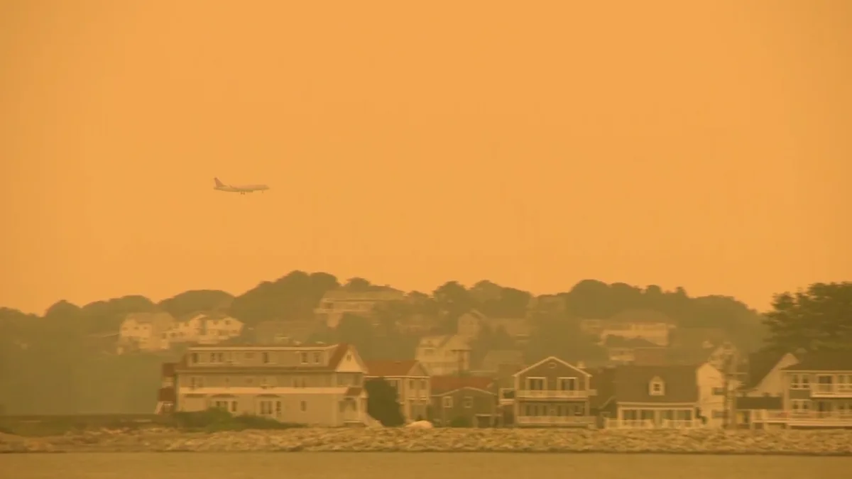 Hazy Boston skyline under wildfire smoke with reduced visibility
