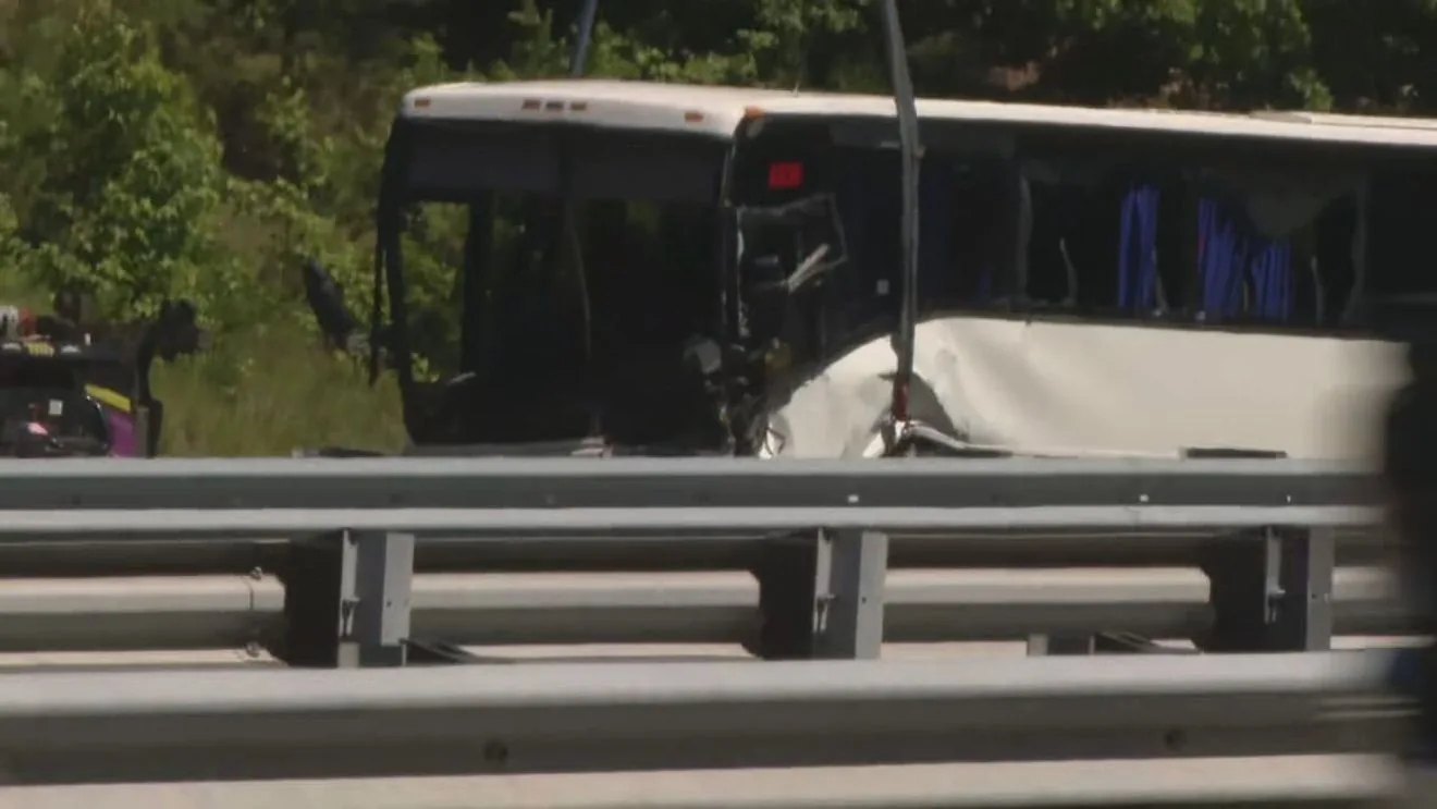 Police and emergency vehicles at the scene of a fatal bus crash on a highway