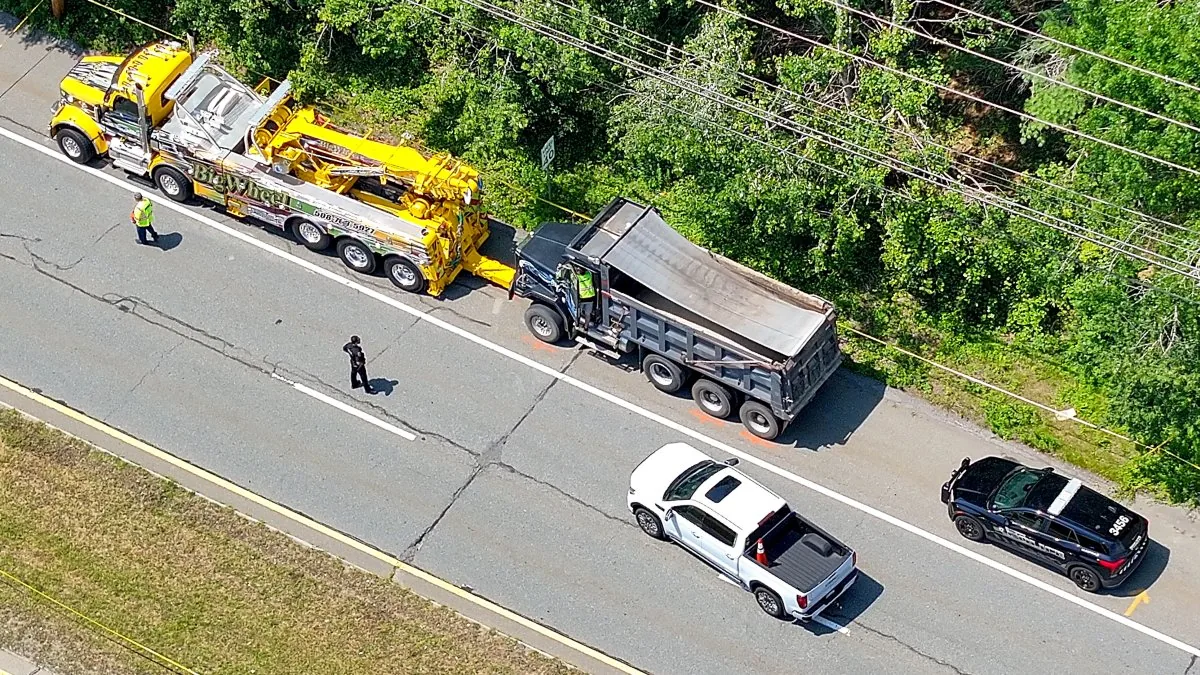 Police vehicles and road closures on Route 6 in Dartmouth after a fatal crash involving a bicycle and dump truck