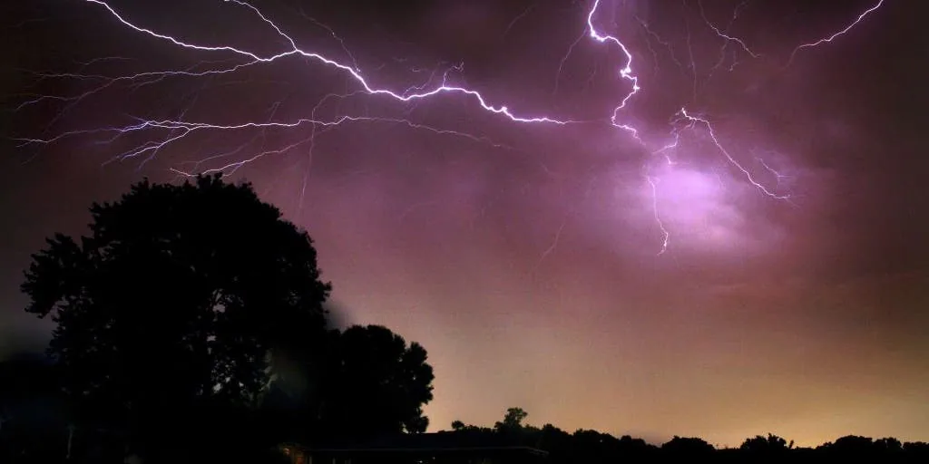 Dark storm clouds moving over a New England landscape during severe weather