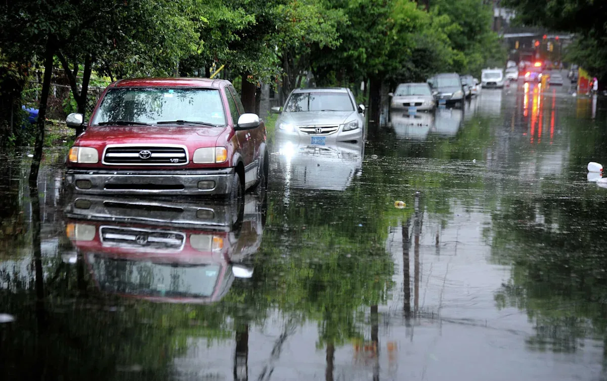 Flooded road in Connecticut with storm water covering a neighborhood street